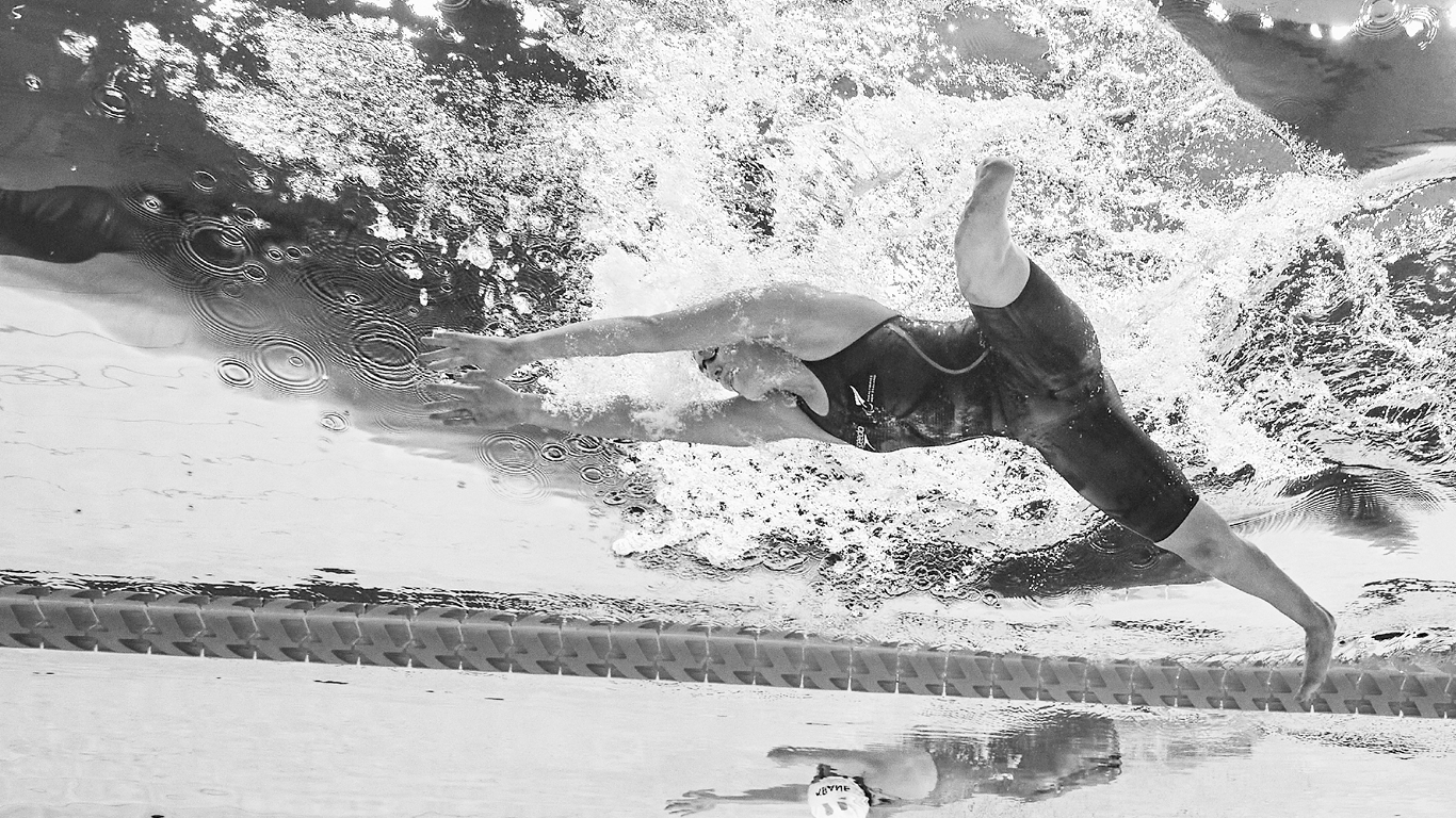 Para swimmer competing, from underneath